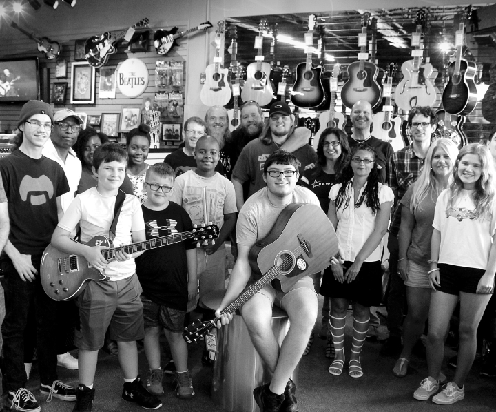 Group photo of Rawkstars students in a music store