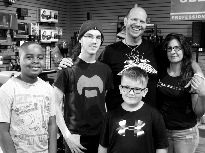 JJ and wife with Rawkstars students in music store