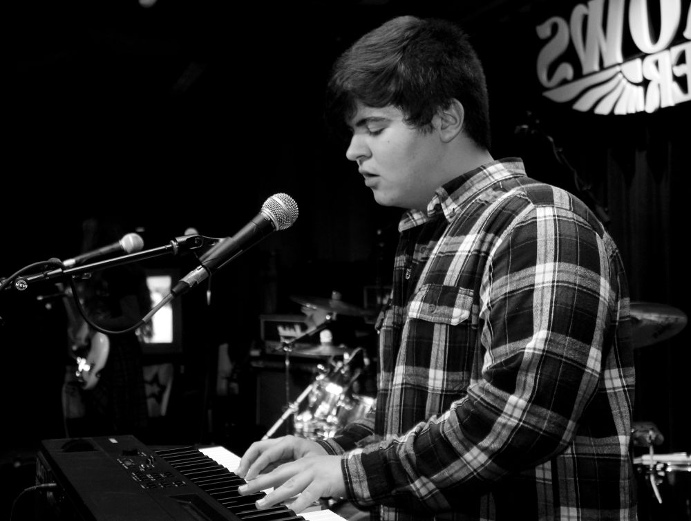 Teenage boy playing keyboard and singing